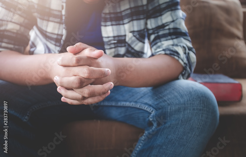 Close up hands of young male praying by believe in God. Christian prayer concept.