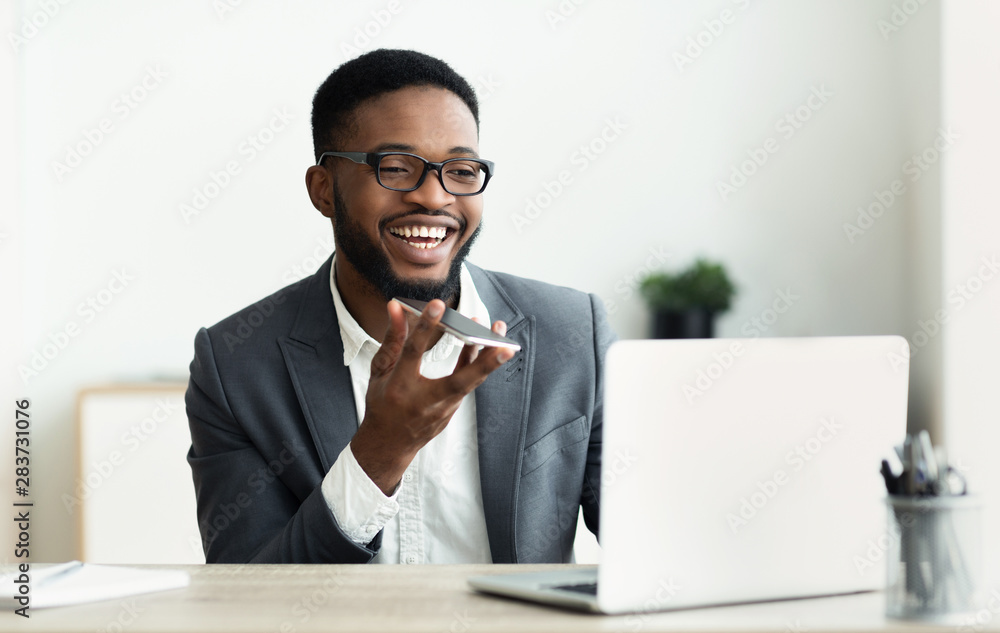 African American businessman using voice assistant on smartphone African American businessman using voice assistant on smartphone