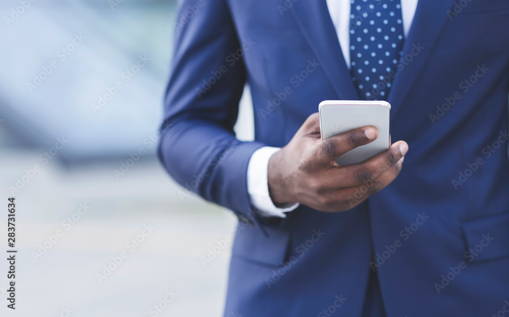 Black Businessman Texting On Cellphone In City, Closeup, Crop Black Businessman Texting On Cellphone In City, Closeup, Crop