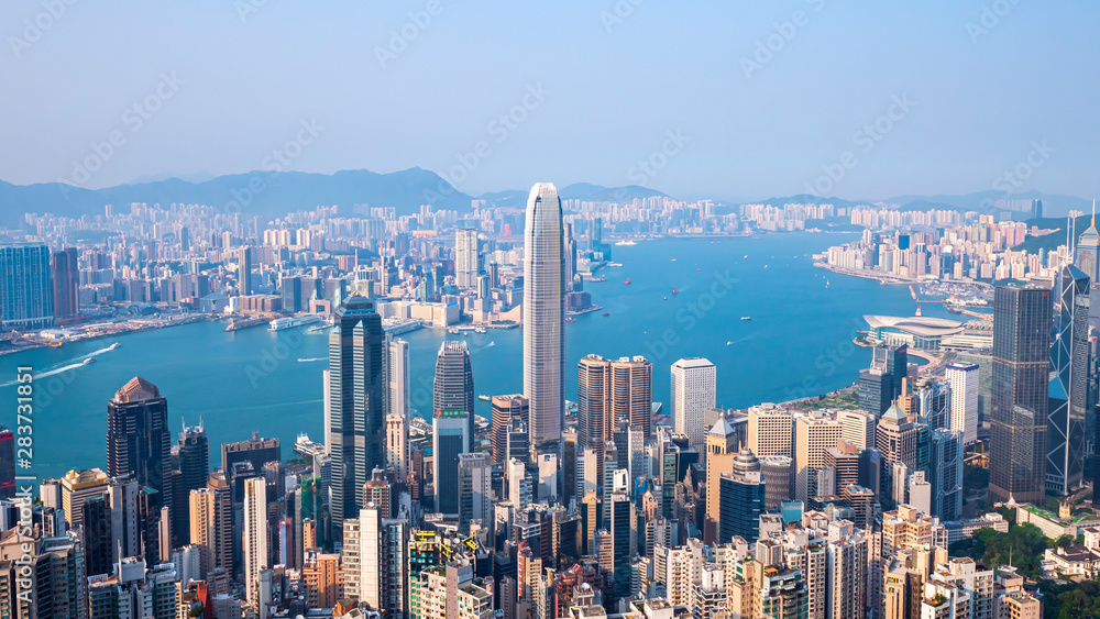 High view of Hong Kong skyline cityscape over Victoria harbour in the afternoon at Victoria Peak