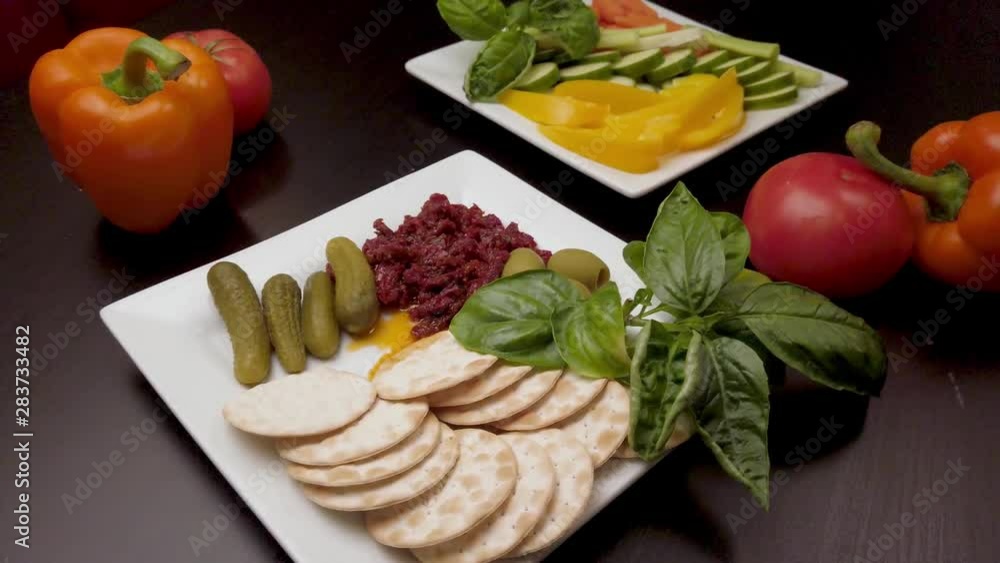 A colorful spread of plates of healthy diet foods like, tomatoes, cucumbers, green olives in 4k. A colorful spread of plates of healthy diet foods like, tomatoes, cucumbers, green olives in 4k.