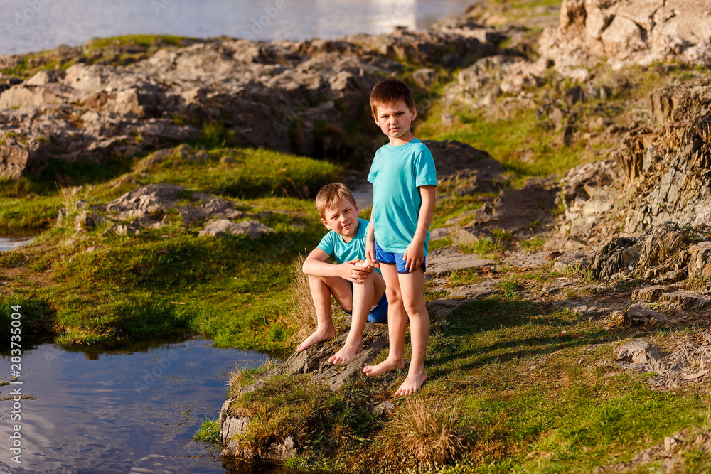 two boys in identical T-shirts and shorts two boys in identical T-shirts and shorts