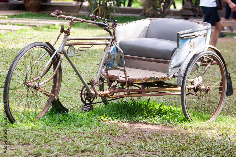 Ancient tricycle In the old house of Thailand