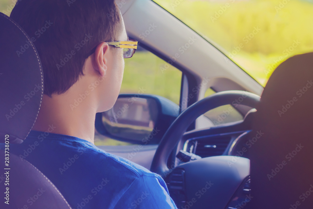 Naklejka premium Young man driving a car