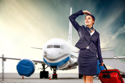 Young stewardess and airplane 