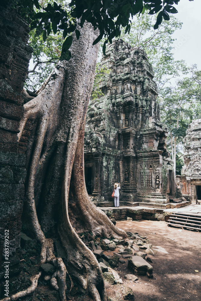 Woman discovering the ruins of Angkor Wat temple complex in Siem Reap, Cambodia