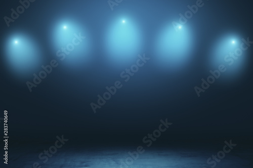 Abstract empty stage in dark hall with blurry spotlights and dark concrete floor.