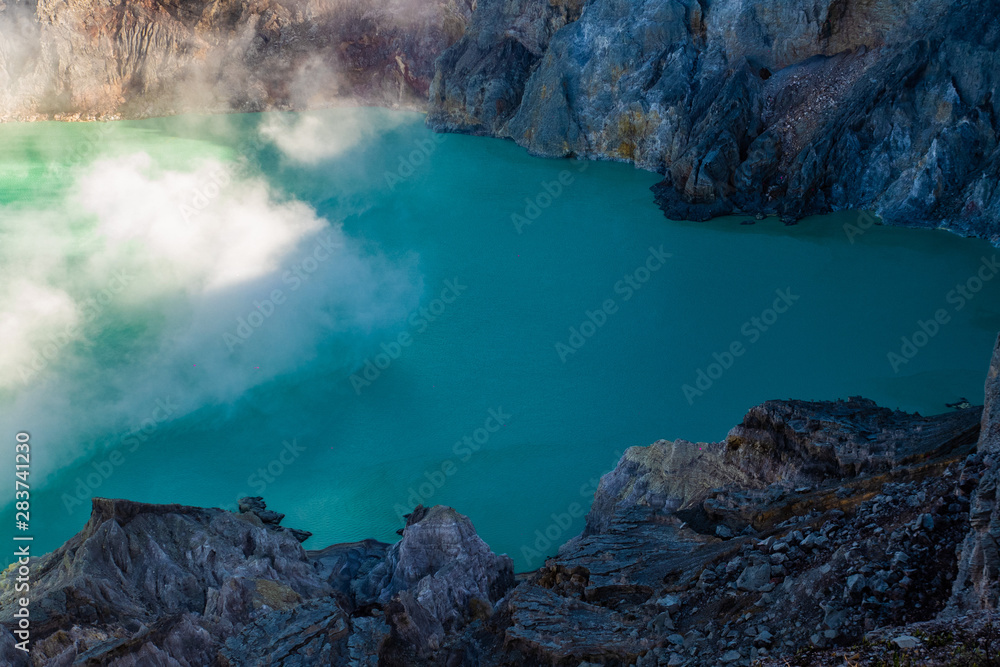 Aerial view of beautiful Ijen volcano with acid lake and sulfur gas going from crater, Indonesia