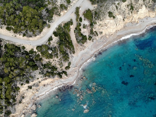 View from top to down. Aegean sea. Clear water. Beach. Stones.