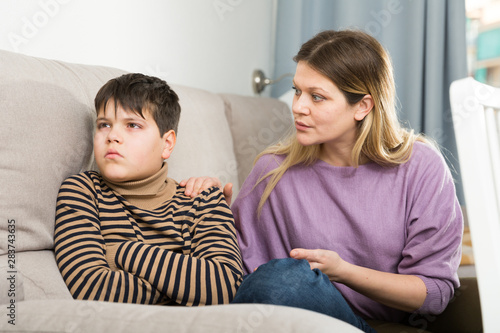 Offended boy and angry mother having quarrel at home