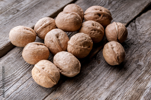 Walnuts on a wooden rustic background. Vegetable protein source