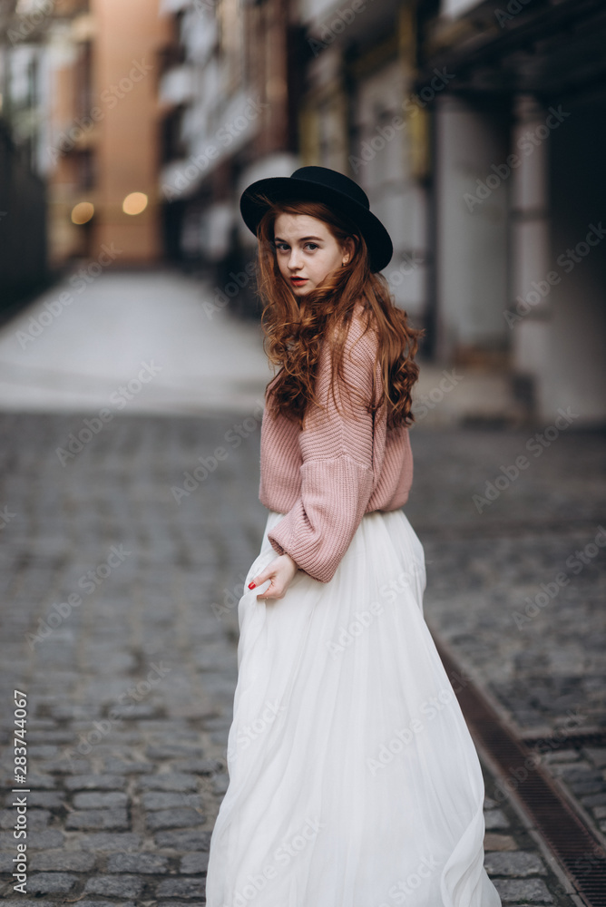 portrait of young redhead woman in wedding dress and sweater