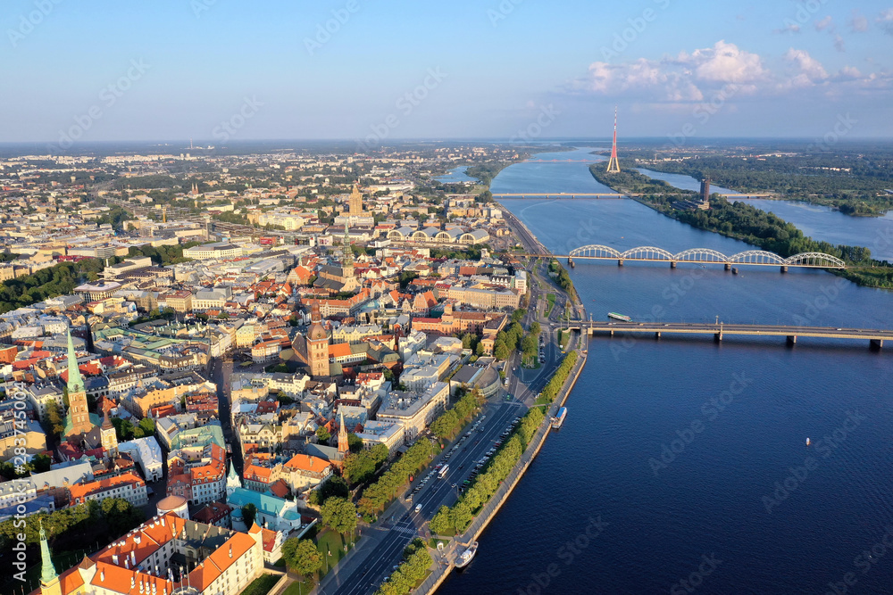 Beautiful view of the old city of Riga from a height, shot on a drone. In the middle Daugava river bridges and TV tower. Panarama with old building. 