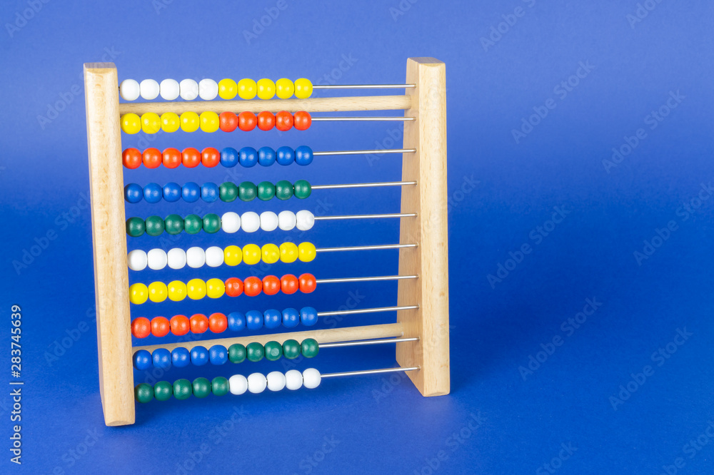 A slide rule with colorful balls, blue background and copy space A slide rule with colorful balls, blue background and copy space