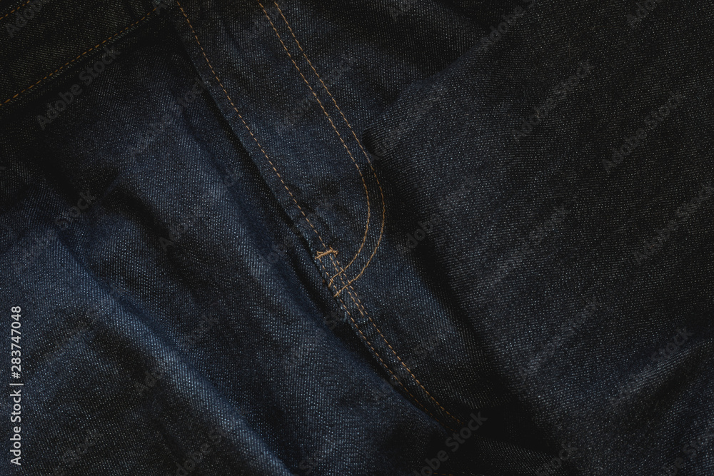 Dark blue jeans background with detailed sewing - Wavy denim textured fabric with zipper seam in detail Dark blue jeans background with detailed sewing - Wavy denim textured fabric with zipper seam in detail
