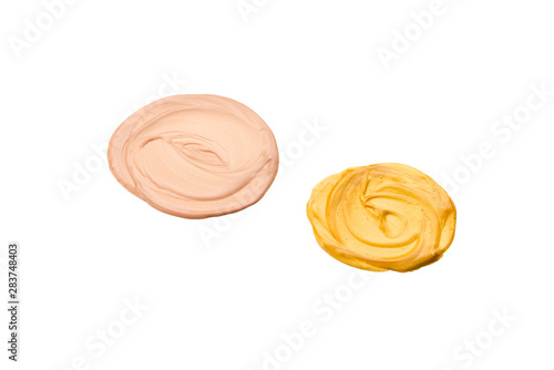 Liquid body and face highlighter isolated on white background. Golden and beige color.  Body cream.