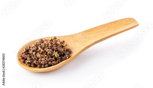 Szetchwan pepper in wood spoon on white background