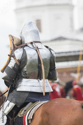 A man knight in helmet riding a brown horse © KONSTANTIN SHISHKIN
