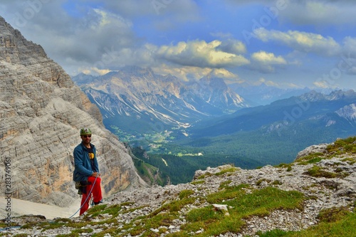 Young man is climbing one of the routes in Dolomites Mountains, Tofana di Roses.
