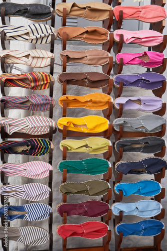 Stand with many fabric espadrilles of different colors