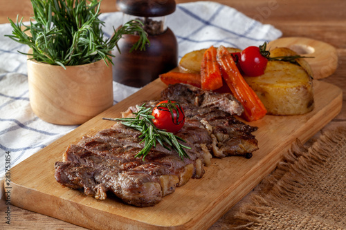Steak on a wooden chopping board, ready to serve