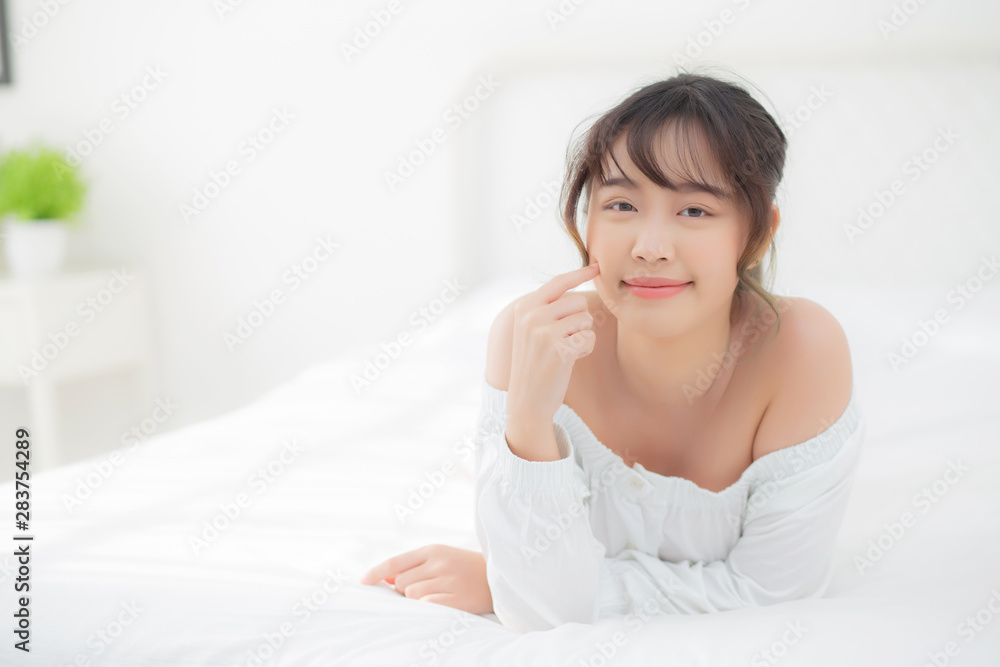Portrait beautiful young asian woman smile while wake up healthy and wellness at morning in the bedroom, beauty asia girl lying skin care and makeup cosmetic with happy, lifestyle and relax concept. Portrait beautiful young asian woman smile while wake up healthy and wellness at morning in the bedroom, beauty asia girl lying skin care and makeup cosmetic with happy, lifestyle and relax concept.