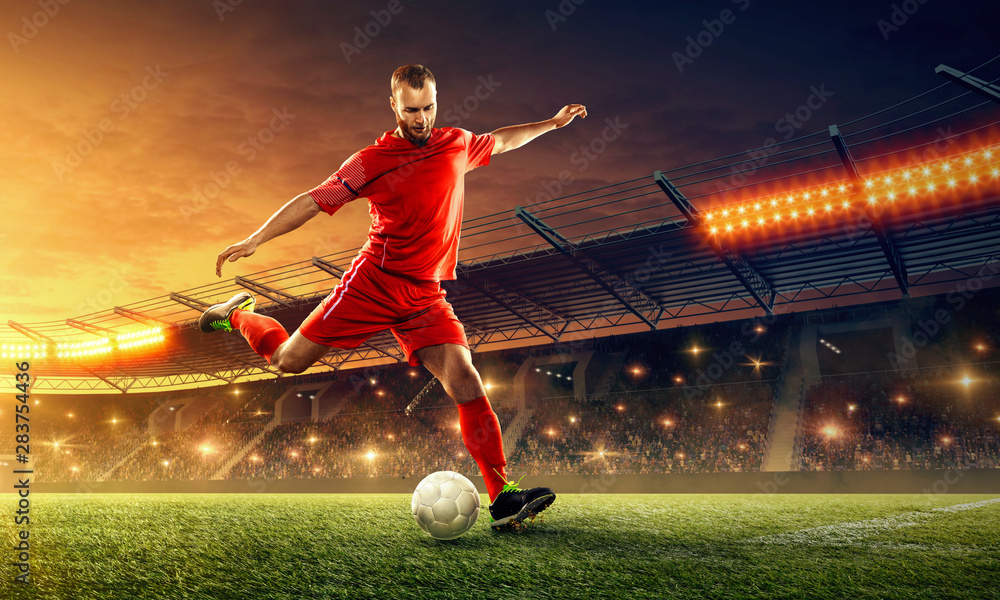 Soccer player in action with a ball on a stadium - obrazy, fototapety, plakaty 
