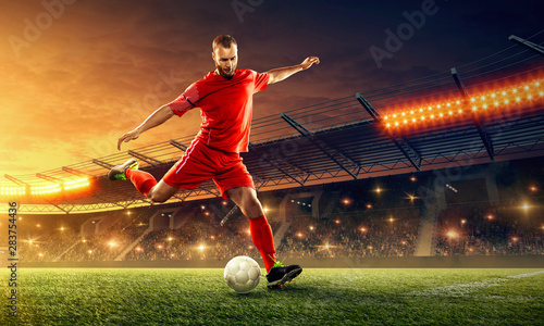 Soccer player in action with a ball on a stadium © TandemBranding