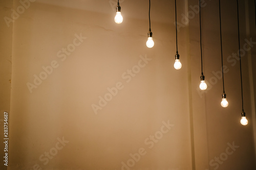 Light bulbs over white wall background