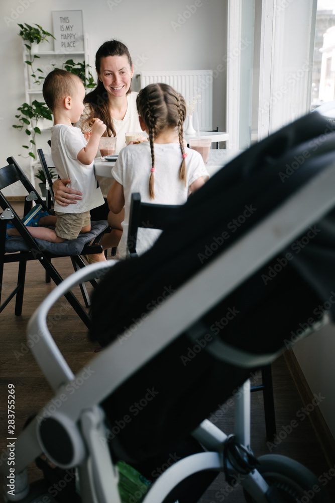 Mother with children drinking hot chocolate and latte at a local coffee shop. They are smiling and having fun. Mother with children drinking hot chocolate and latte at a local coffee shop. They are smiling and having fun.