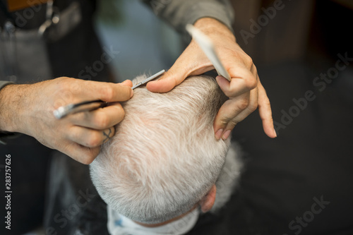 Hairdresser doing haircut to client in studio