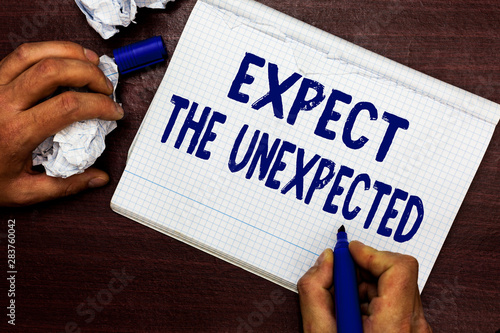 Writing note showing Expect The Unexpected. Business photo showcasing Anything can Happen Consider all Possible Events Man holding marker notebook page crumpled paper several tries mistakes