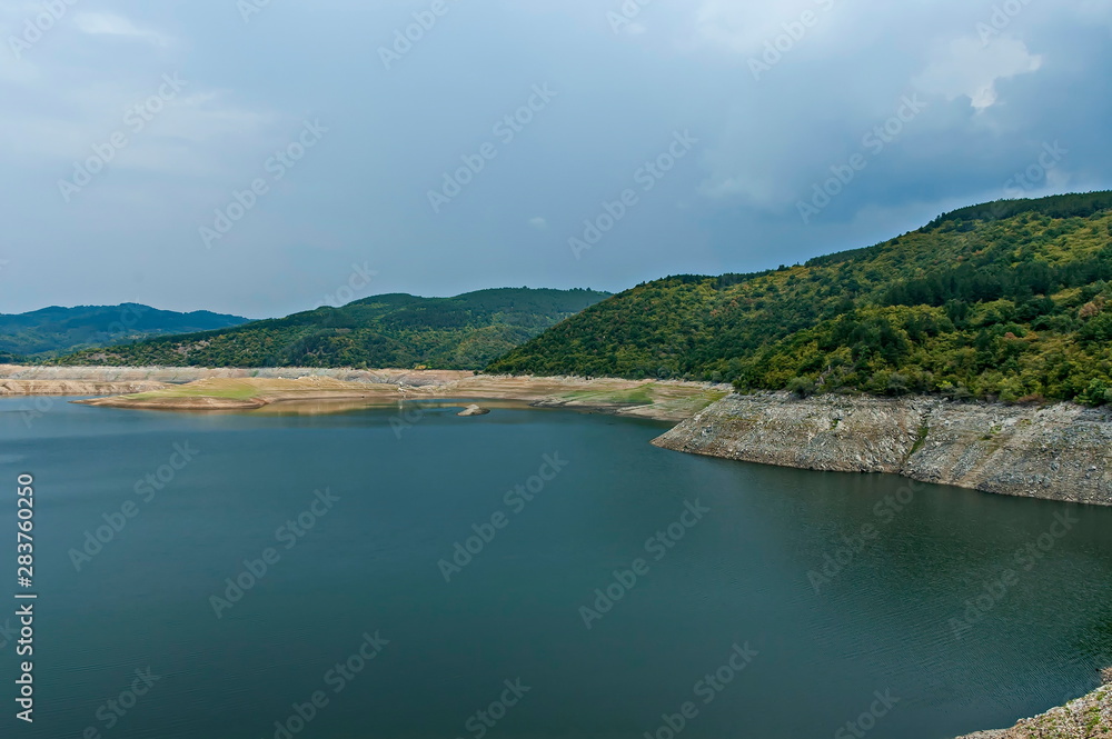 View of the Topolnitsa dam, reservoir, lake or barrage on the river Topolnitsa near village Muhovo, Ihtiman region, Bulgaria, Europe View of the Topolnitsa dam, reservoir, lake or barrage on the river Topolnitsa near village Muhovo, Ihtiman region, Bulgaria, Europe