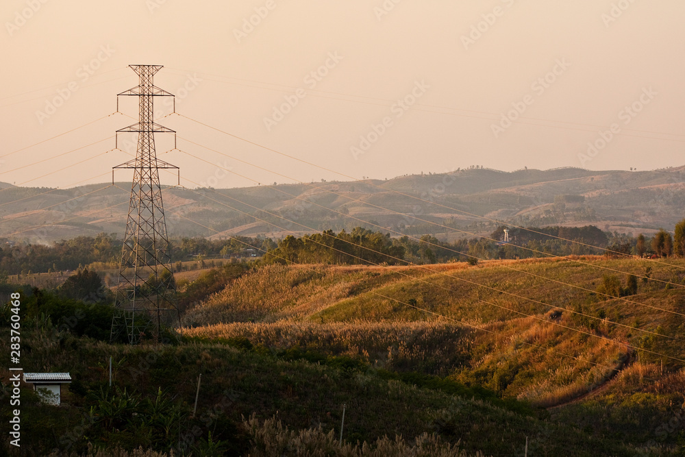 Electricity pylons and transmission lines at dusk