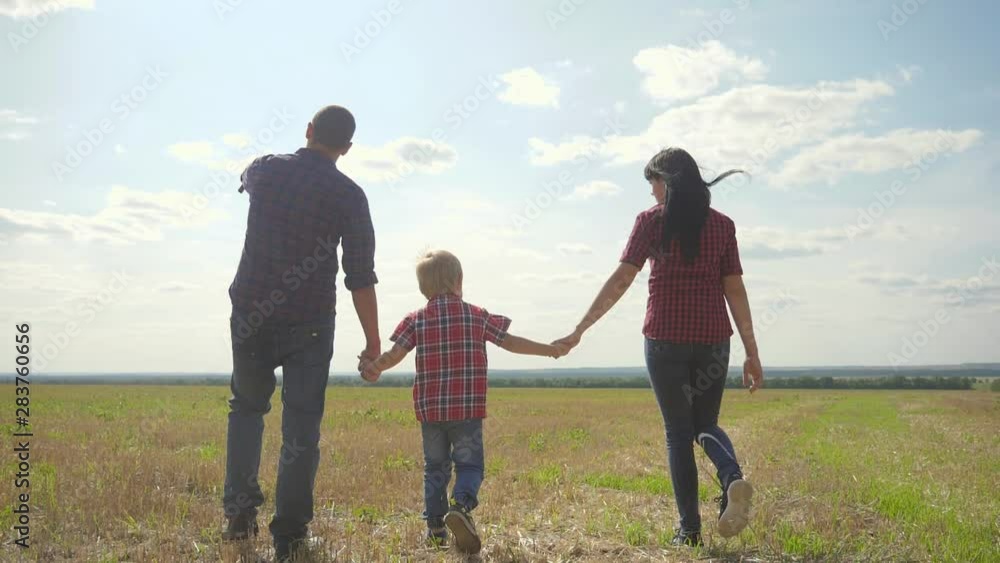 happy family walking nature teamwork friendship care concept slow motion video. father mom and son walk lifestyle in nature sunset sunlight hold hand. happy family parents man and girl hold little boy happy family walking nature teamwork friendship care concept slow motion video. father mom and son walk lifestyle in nature sunset sunlight hold hand. happy family parents man and girl hold little boy