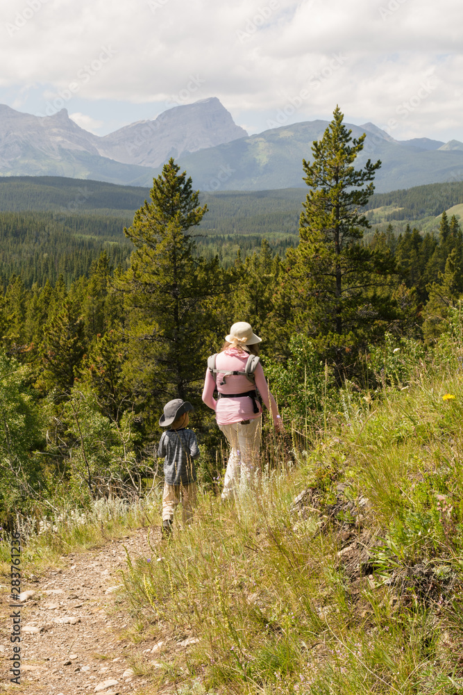Woman and boy hiking in the mountains