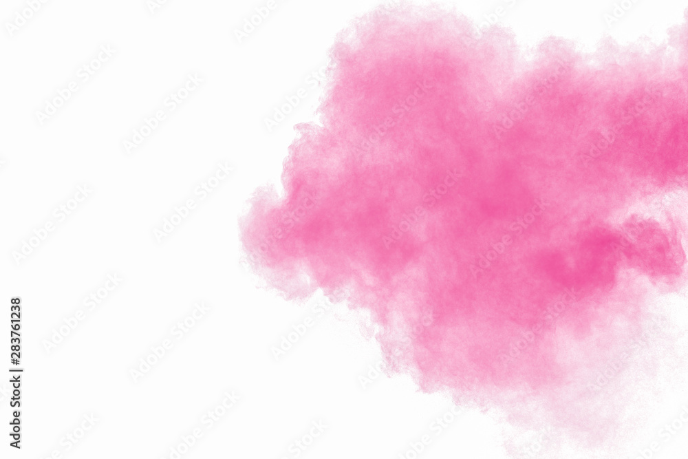 Abstract pink powder explosion on white background. Freeze motion of pink dust splattered.