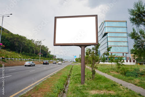Empty billboard by the road, place for your advertisement and text