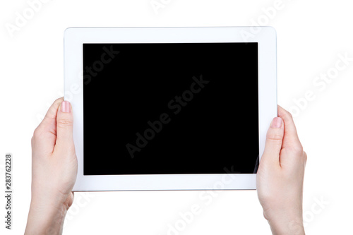 Tablet computer in female hands isolated on white background