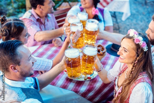 People enjoying food and drink in Bavarian beer garden photo