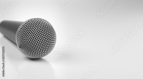 Macro shot of microphone on white glossy table with dof effect.