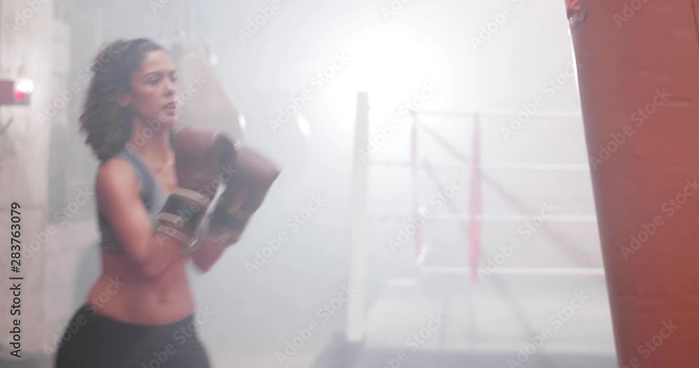 Female exercising with a a punch bag Female exercising with a a punch bag