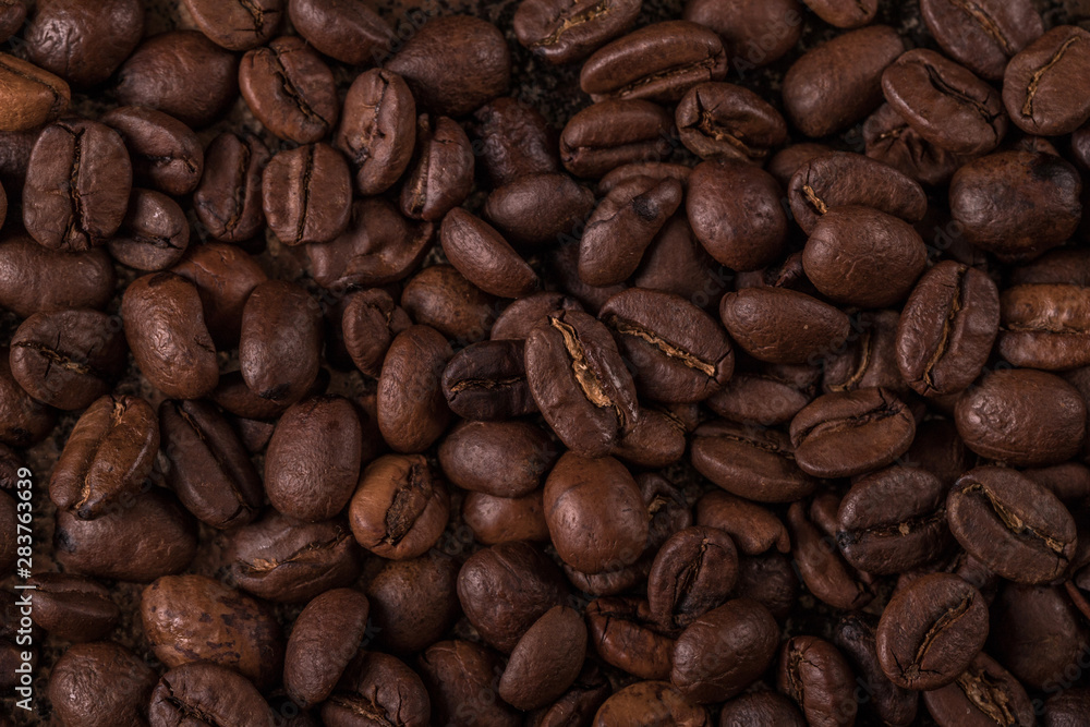 Coffee beans on stone background. Top view with copy space for your text. Roasted coffee beans background. Beans texture, macro Coffee beans on stone background. Top view with copy space for your text. Roasted coffee beans background. Beans texture, macro