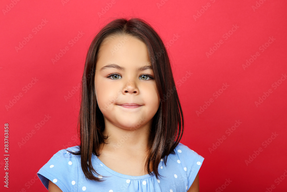 Beautiful little girl in blue dress on red background Beautiful little girl in blue dress on red background