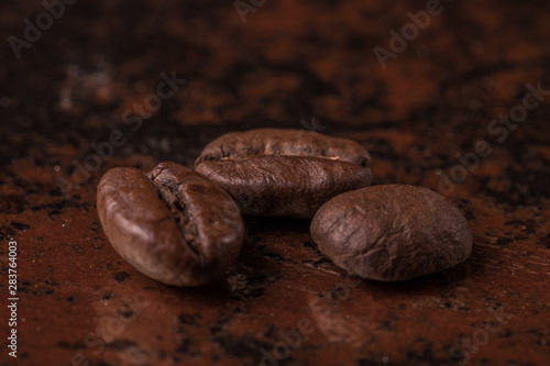Coffee beans on stone background. Top view with copy space for your text. Roasted coffee beans background. Beans texture, macro