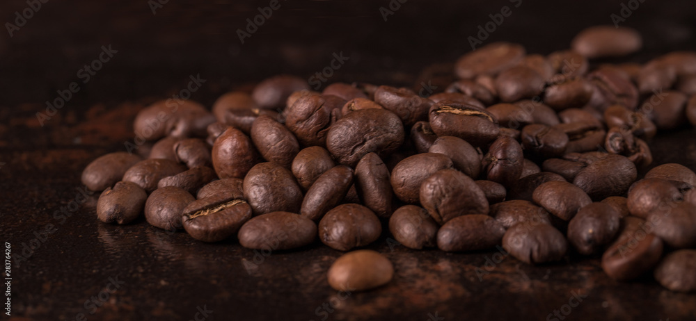 Coffee beans on stone background. Top view with copy space for your text. Roasted coffee beans background. Beans texture, macro Coffee beans on stone background. Top view with copy space for your text. Roasted coffee beans background. Beans texture, macro