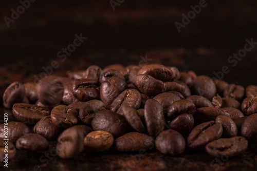 Coffee beans  on stone background. Top view with copy space for your text. Roasted coffee beans background. Beans texture, macro