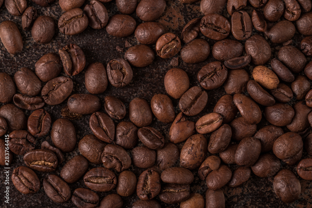 Coffee beans on stone background. Top view with copy space for your text. Roasted coffee beans background. Beans texture, macro Coffee beans on stone background. Top view with copy space for your text. Roasted coffee beans background. Beans texture, macro