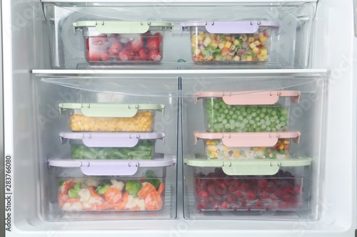 Boxes with different products inside of refrigerator