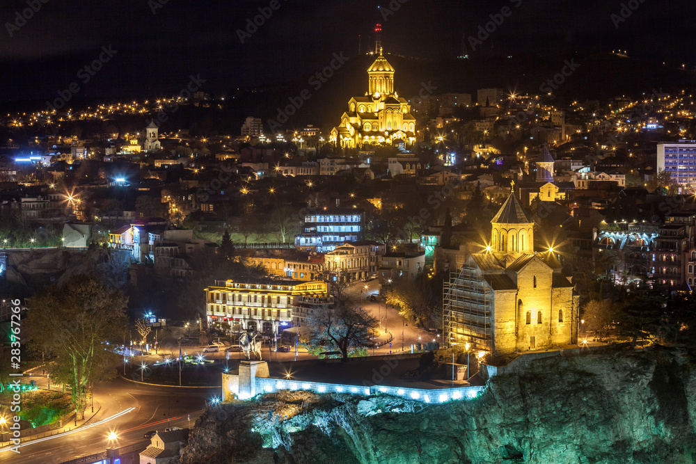 Night view of Tbilisi with Sameba (Trinity) Church and other landmarks. Travel.